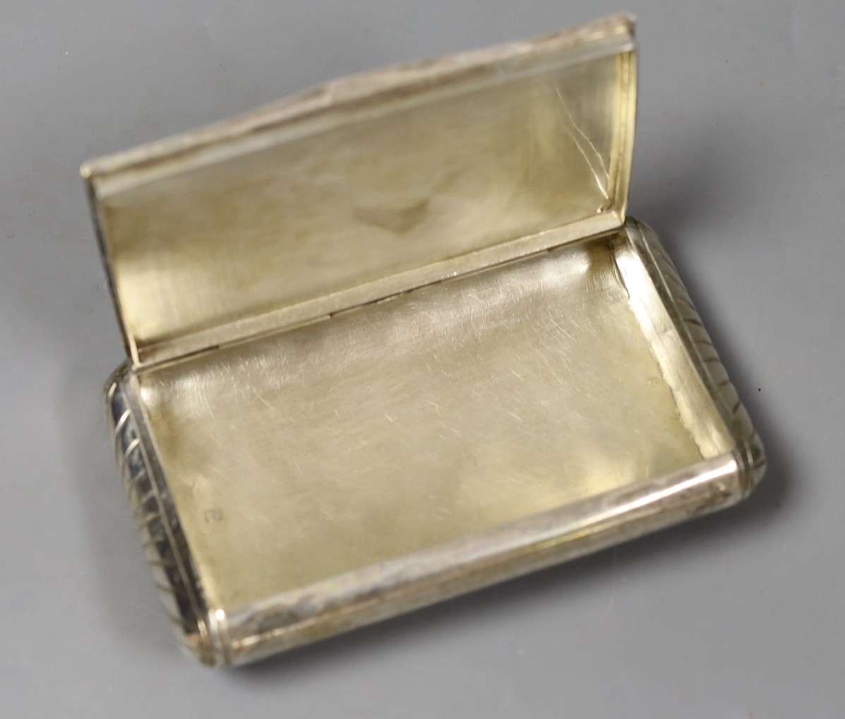 A 19th century Dutch 833 standard white metal tobacco box, engraved with a church in landscape scene, 13.2cm, 159 grams.